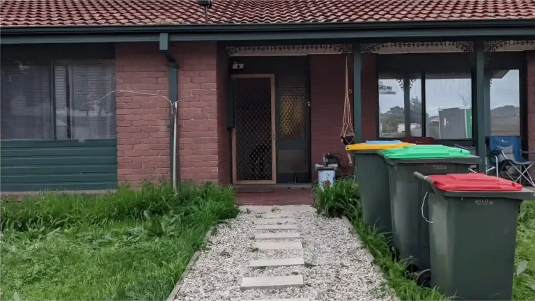 Melbourne Property Preparers before photo of suburban front yard in Melbourne with overgrown grass multiple wheelie bins and cluttered porch area prior to property maintenance and presentation