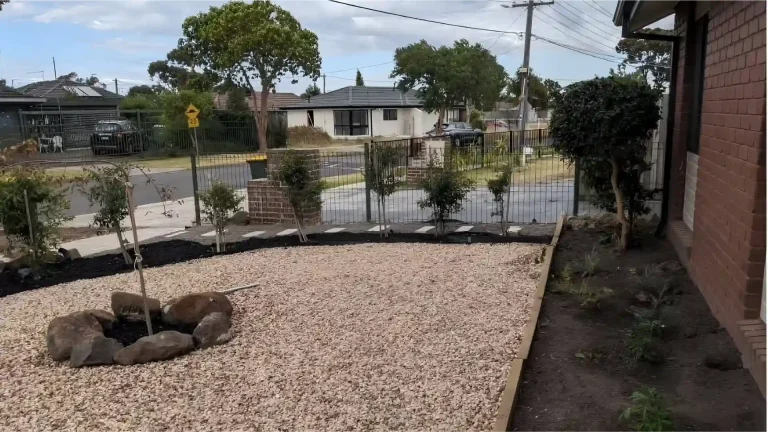 Melbourne Property Preparers after photo of landscaped front yard in Melbourne with gravel garden bed young tree brick retaining wall and neatly planted shrubs for improved property presentation