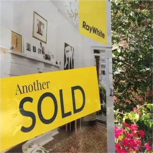 Melbourne Property Preparers sold property sign in Melbourne with Ray White branding and view of stylishly decorated interior representing successful real estate transaction and property presentation