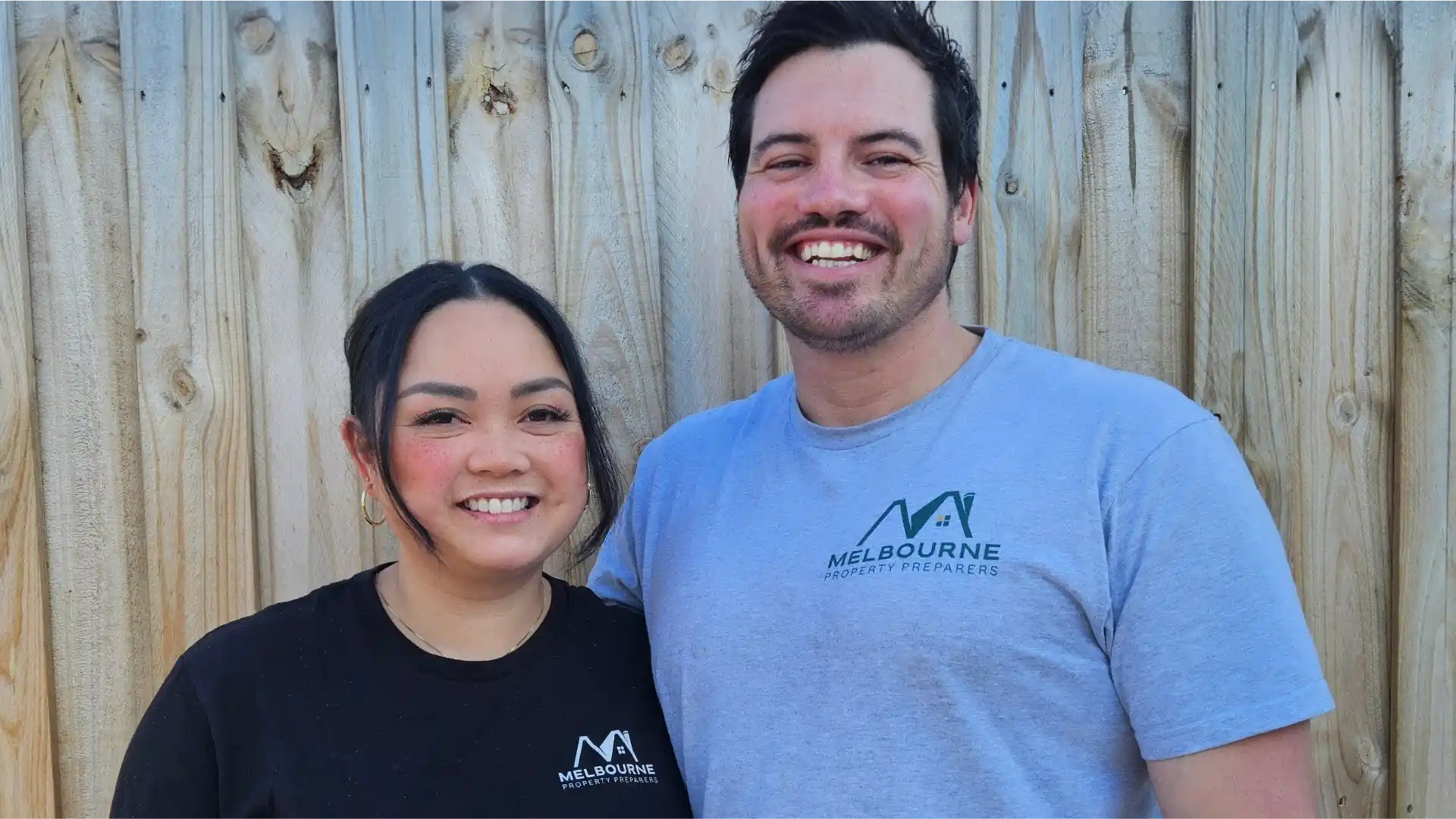 Melbourne Property Preparers team members standing in front of wooden fence wearing branded uniforms in Melbourne representing professional property preparation services
